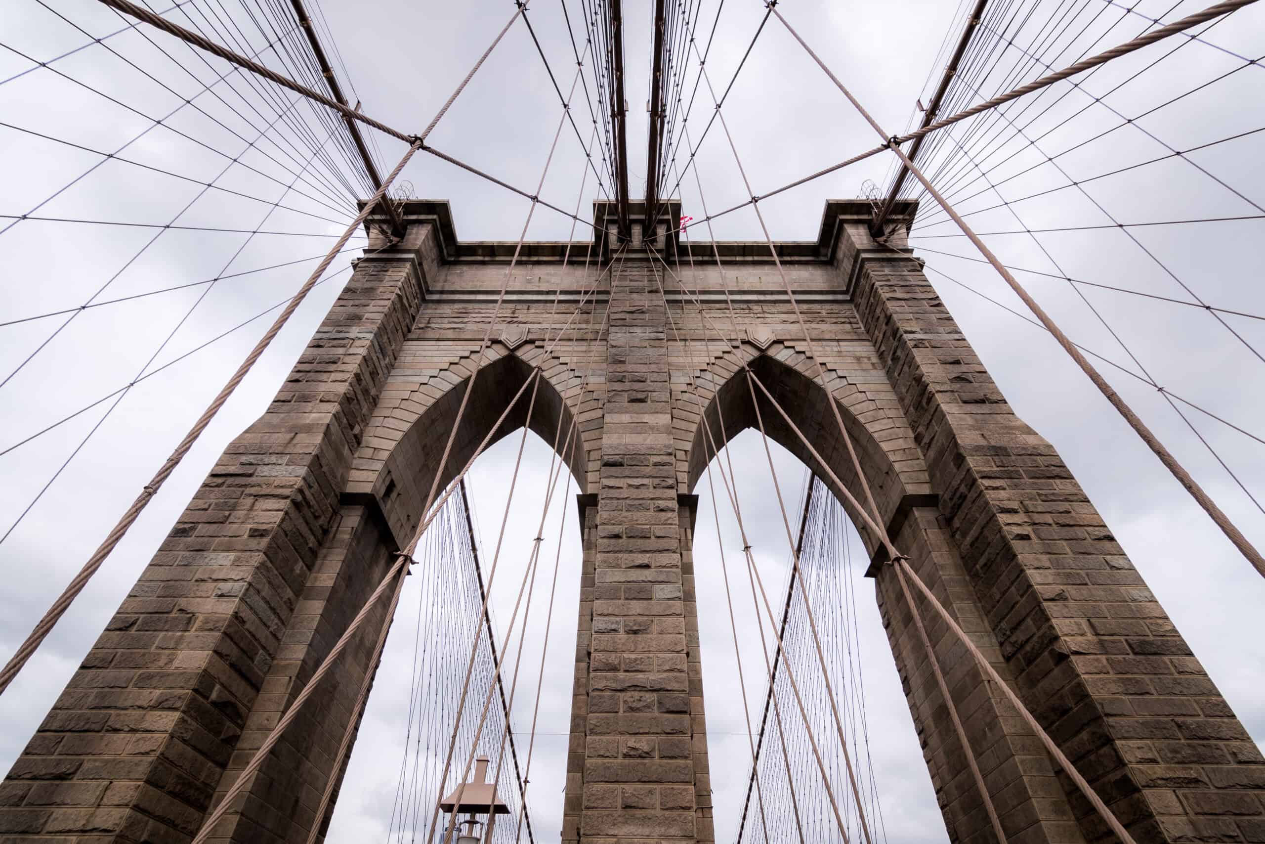 Sweeping gothic view of the Brooklyn Bridge cables and arches