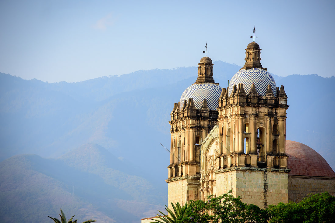 Santo Domingo’s twin bell towers against the sky at blue hour, Oaxaca