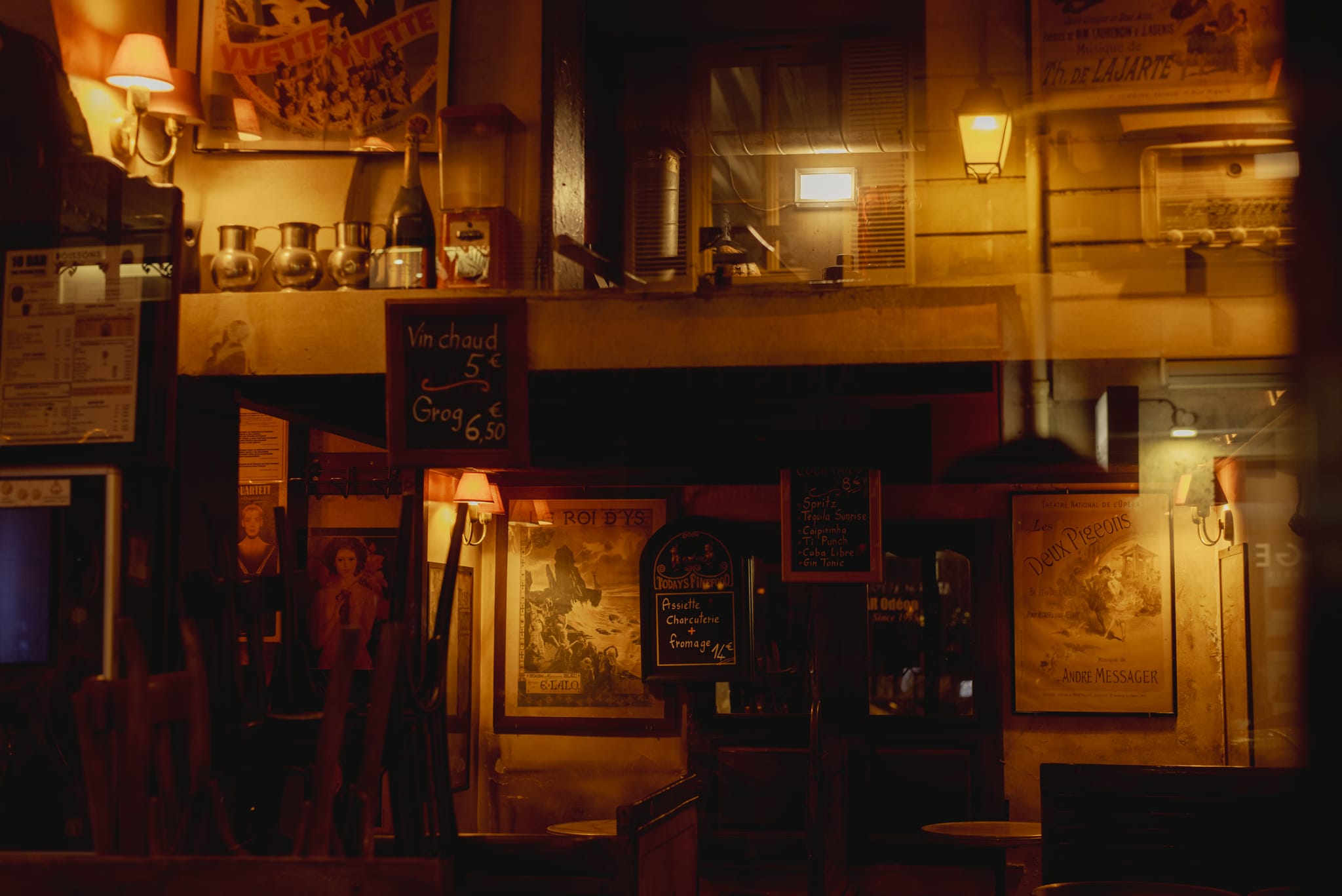 A small bookshop glowing warm at night