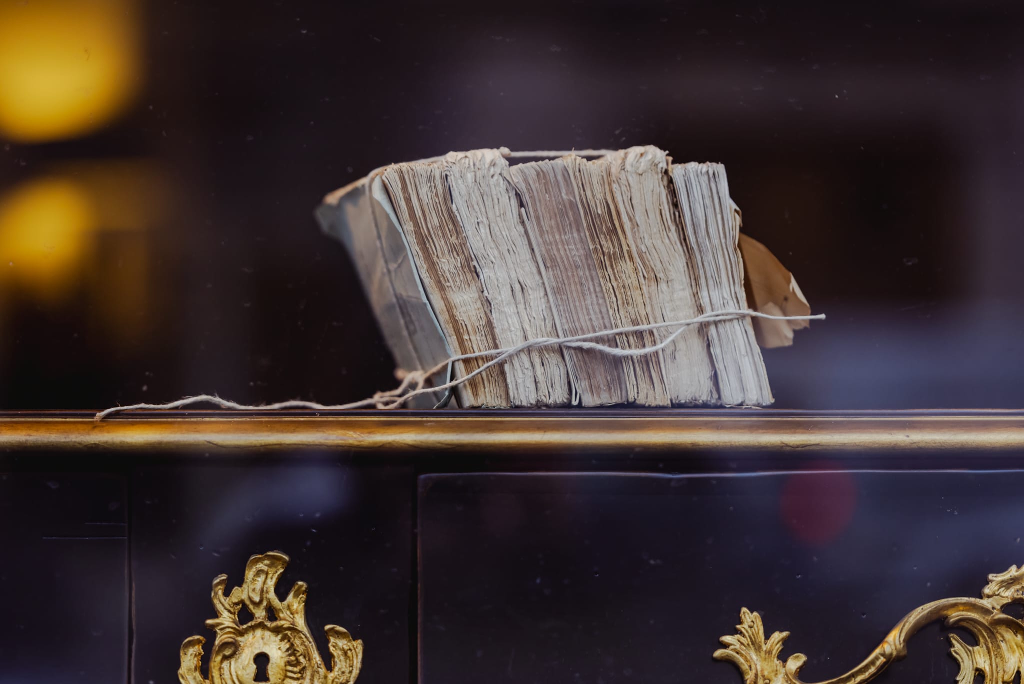 A bundle of old papers tied with string in a Paris shop window