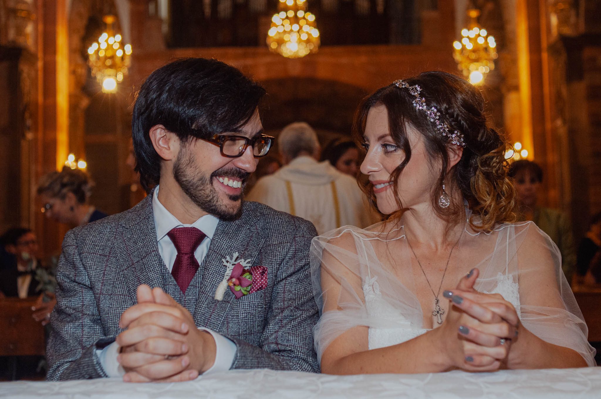 Groom and bride smiling at each other during their ceremony at La Parroquia