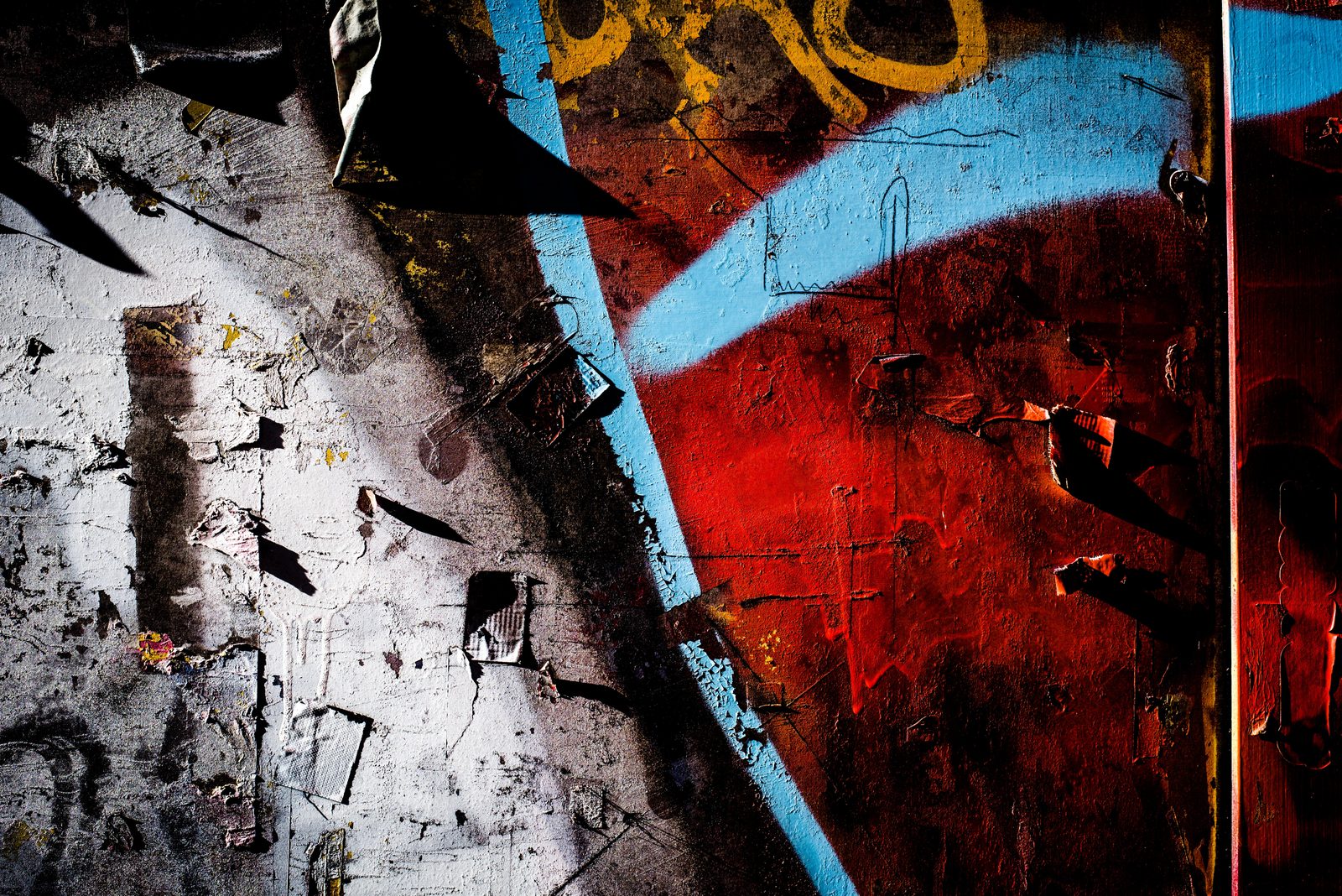 Layers of torn posters and paint on a Freiburg wall