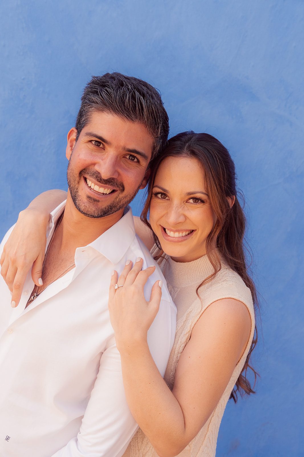 Smiling against a blue wall