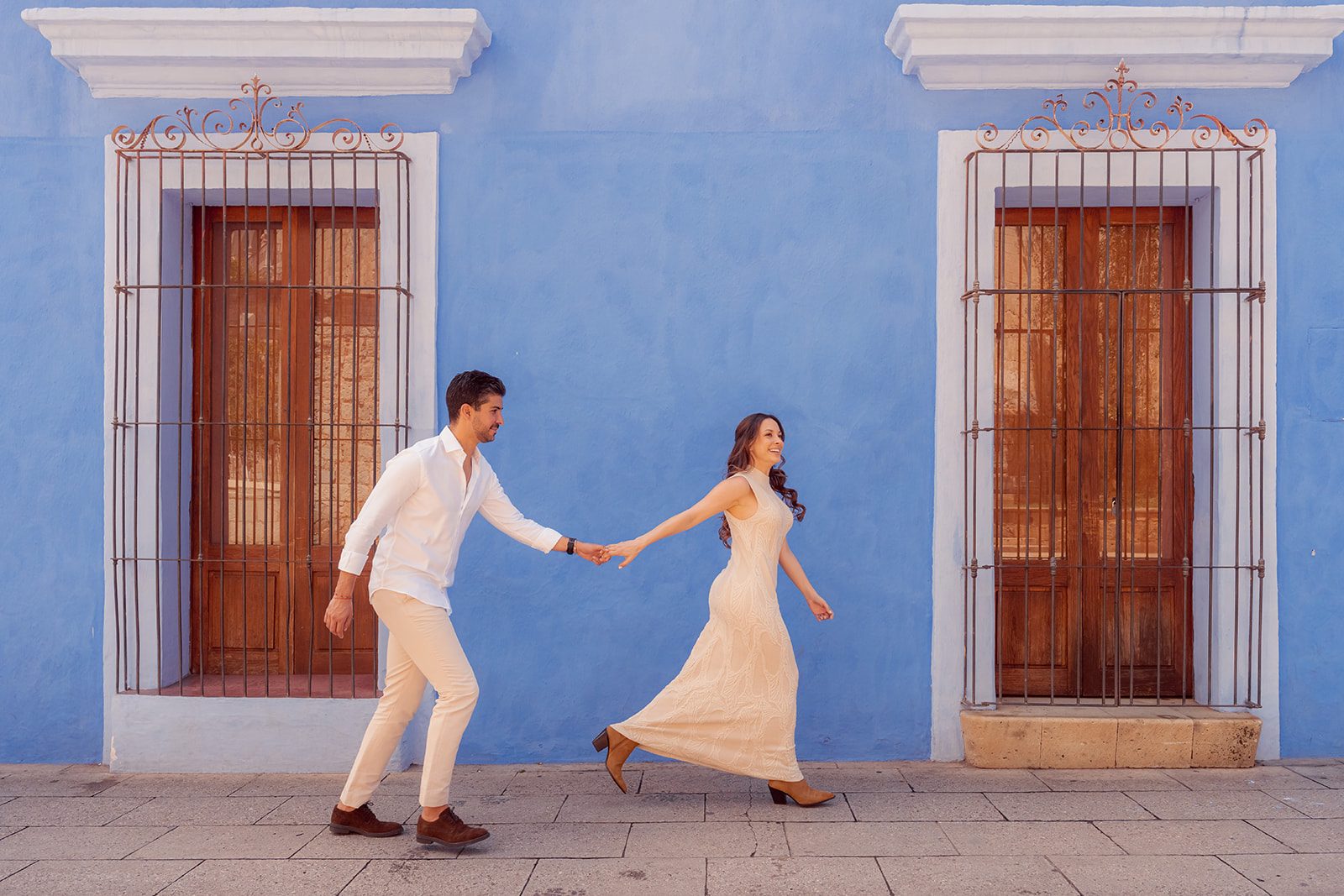 Dancing past a blue wall