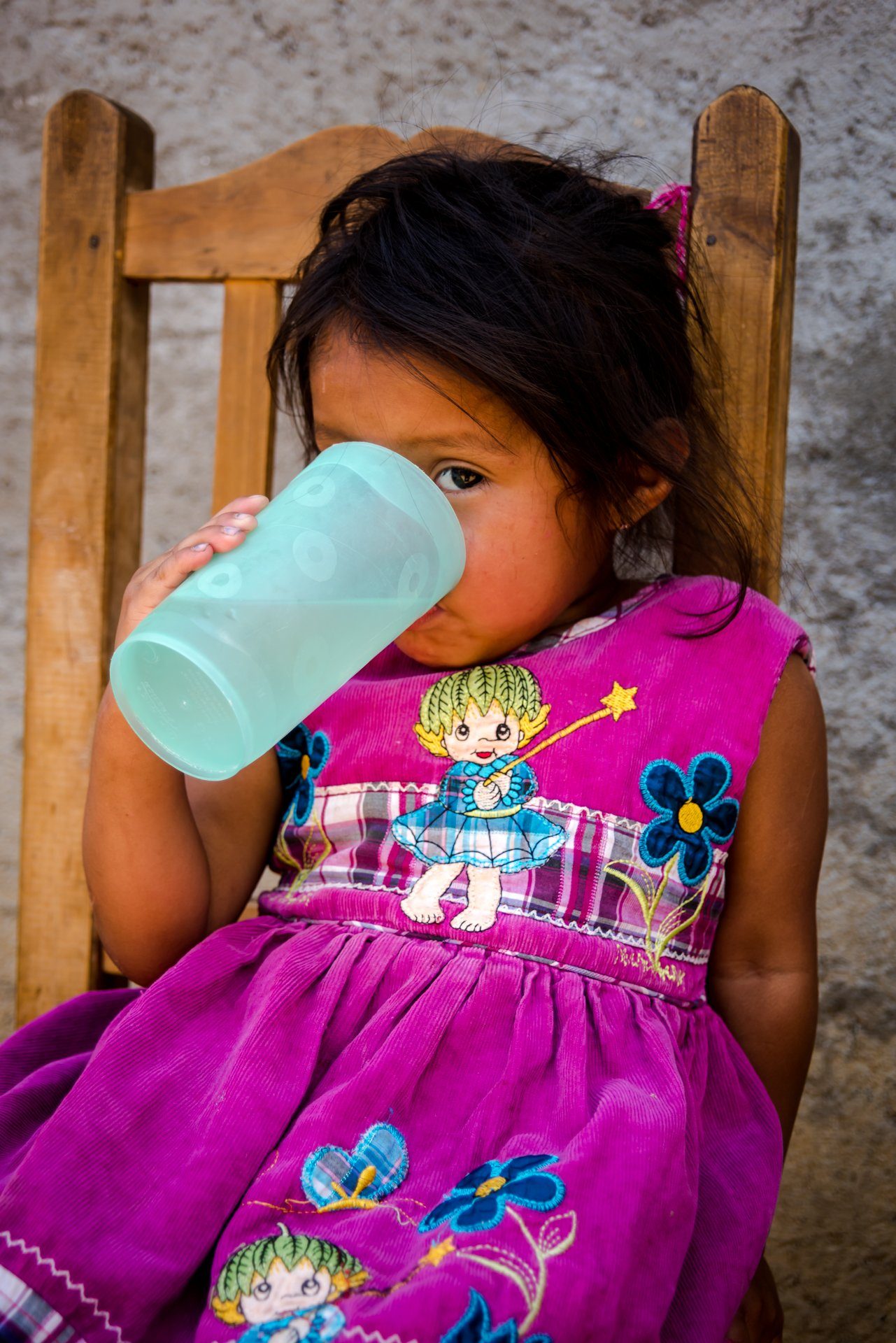 A girl drinking from a cup
