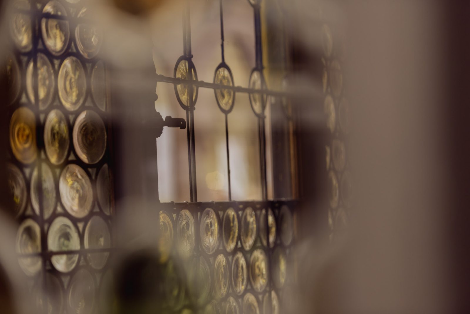 Round bull’s-eye window panes, out of focus, on Place de la Cathédrale